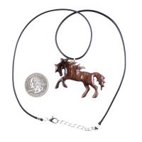 A wooden horse pendant necklace with a black cord and silver lobster clasp. The horse is brown and has a detailed mane and tail.