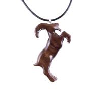 A wooden pendant shaped like a goat standing on its hind legs. The pendant is brown and has a natural wood grain pattern. The pendant is hanging from a black cord.
