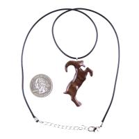 A wooden pendant shaped like a goat standing on its hind legs. The pendant is brown and has a natural wood grain pattern. The pendant is hanging from a black cord with silver lobster clasp.