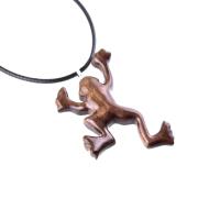 A brown frog pendant on a black cord necklace. The frog is in a jumping pose with its legs outstretched.
