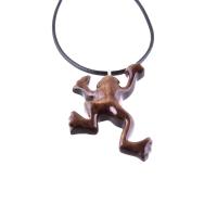 A brown frog pendant on a black cord necklace. The frog is in a jumping pose with its legs outstretched.