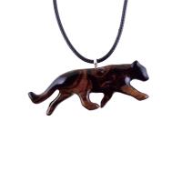 A dark reddish-brown wooden panther pendant necklace. The panther is carved in a leaping pose and hangs from a black cord. The pendant is intricately detailed and shows the wood grain. This handcrafted necklace is a unique and stylish accessory.