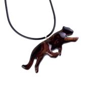 Dark reddish-brown wooden panther necklace pendant on a black cord. The panther is carved in a leaping pose, showcasing intricate wood grain details.  The pendant features a smooth, polished finish and hangs from a simple black cord necklace. This handcrafted necklace is a unique and stylish accessory, perfect for animal lovers and those who appreciate nature-inspired jewelry.
