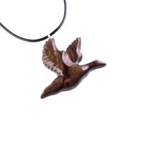 A dark brown wooden duck pendant on a black cord necklace. The bird is carved in flight with its wings spread out.