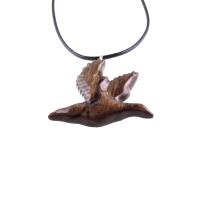 A dark brown wooden duck pendant on a black cord necklace. The bird is carved in flight with its wings spread out.