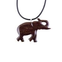 A dark brown wooden elephant pendant necklace with a black cord. The elephant is carved in a walking pose with its trunk raised.