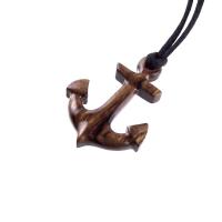A wooden anchor pendant necklace with black satin cord.