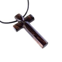 A dark brown wooden cross pendant on a black cord. It has a glossy smooth finish showing the wood grain.