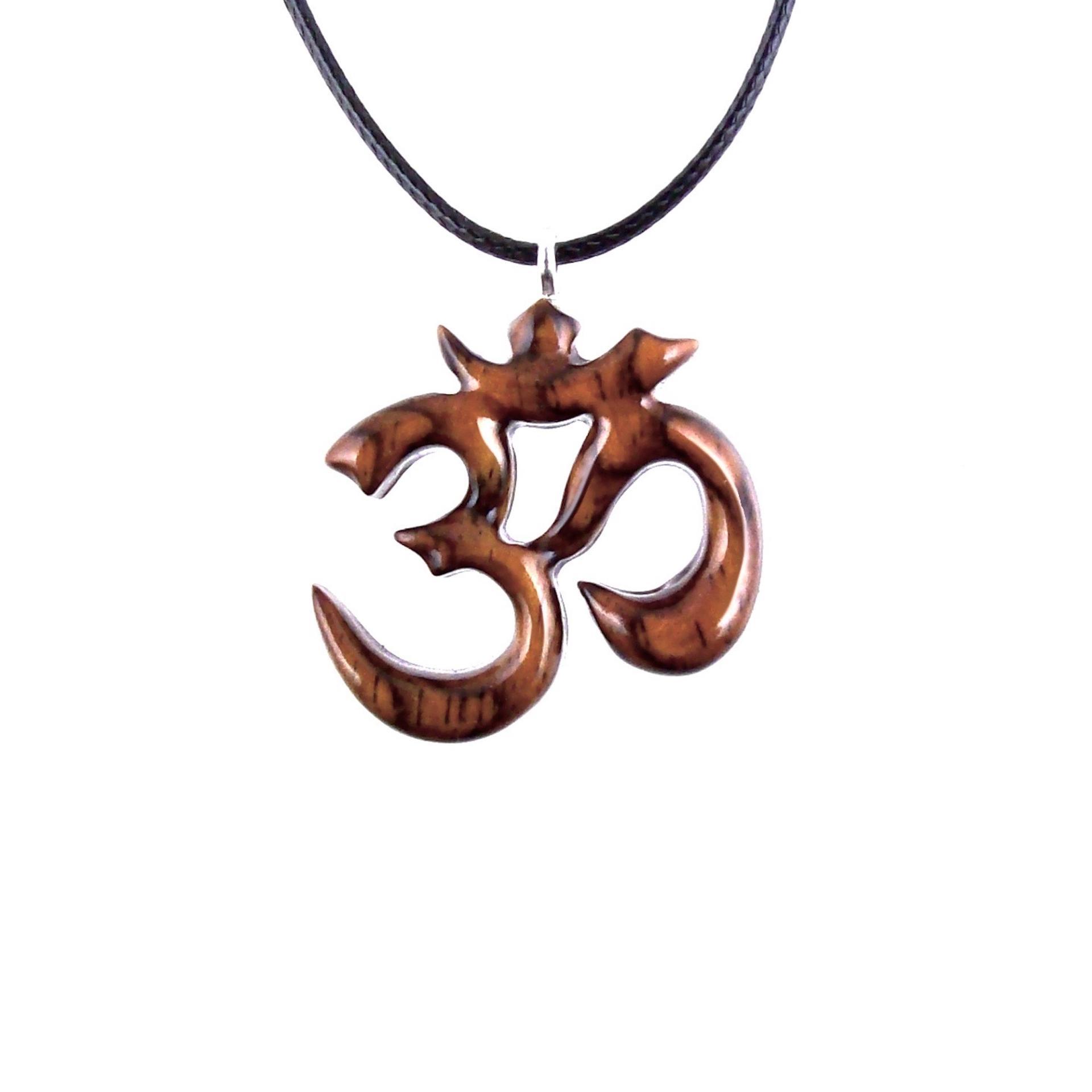 Reddish-brown wooden om pendant with 18 inches black cord necklace with lobster clasp.