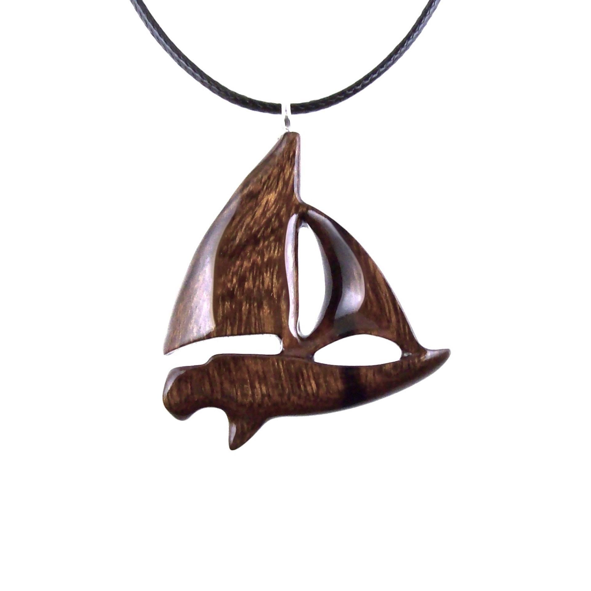 Brown reversible wooden sailboat pendant with 18 inches black cord necklace with lobster clasp.