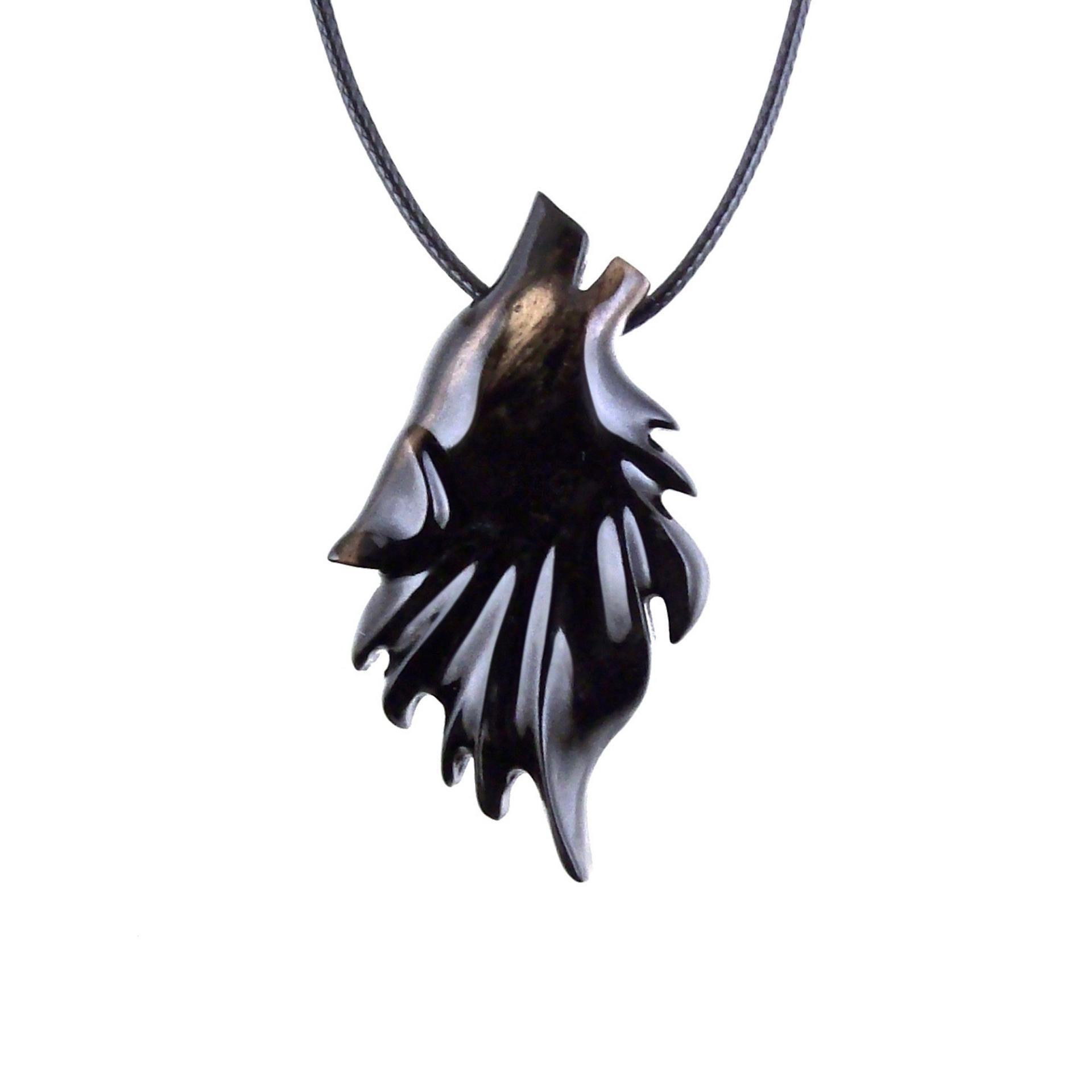 Black with cream streaks wooden howling wolf head pendant with 18 inches black cord necklace with lobster clasp.