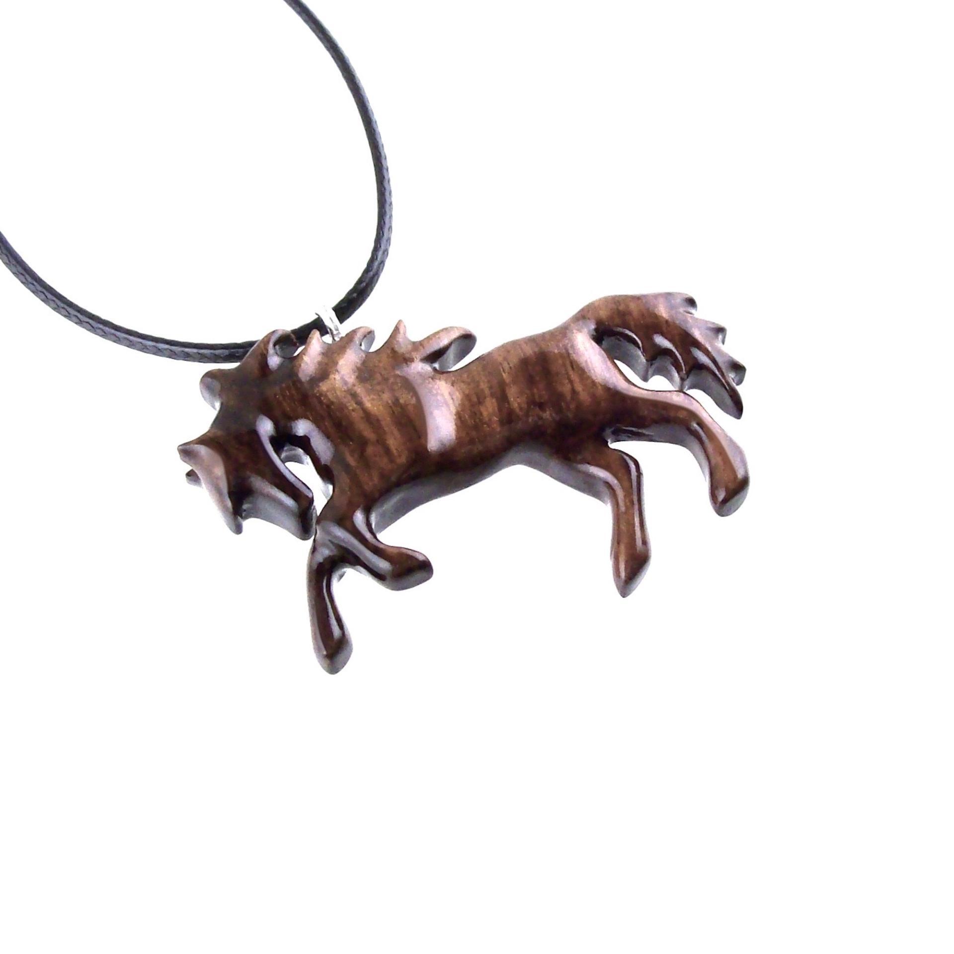A wooden horse pendant necklace with a black cord. The horse is brown and has a detailed mane and tail.