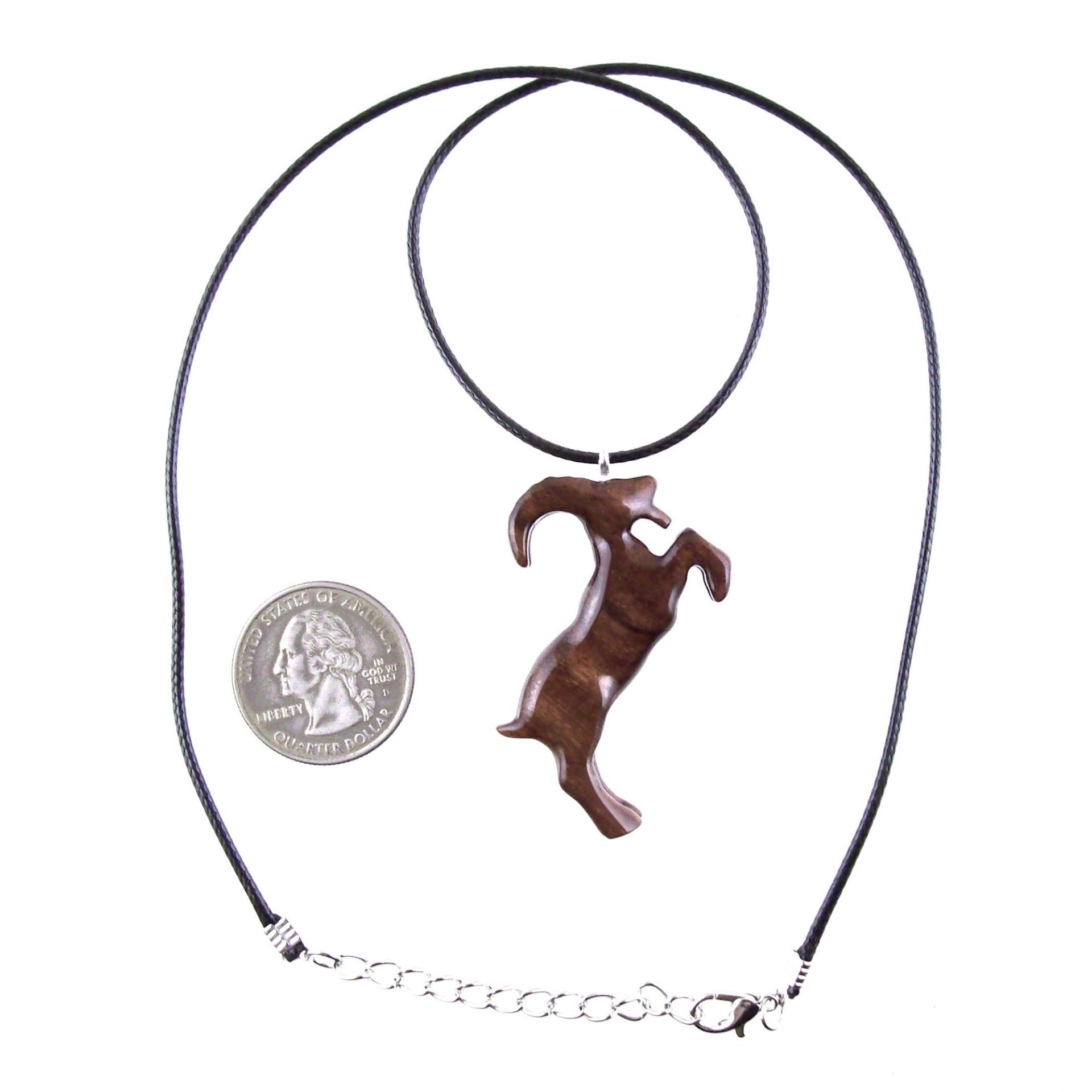 A wooden pendant shaped like a goat standing on its hind legs. The pendant is brown and has a natural wood grain pattern. The pendant is hanging from a black cord with silver lobster clasp.