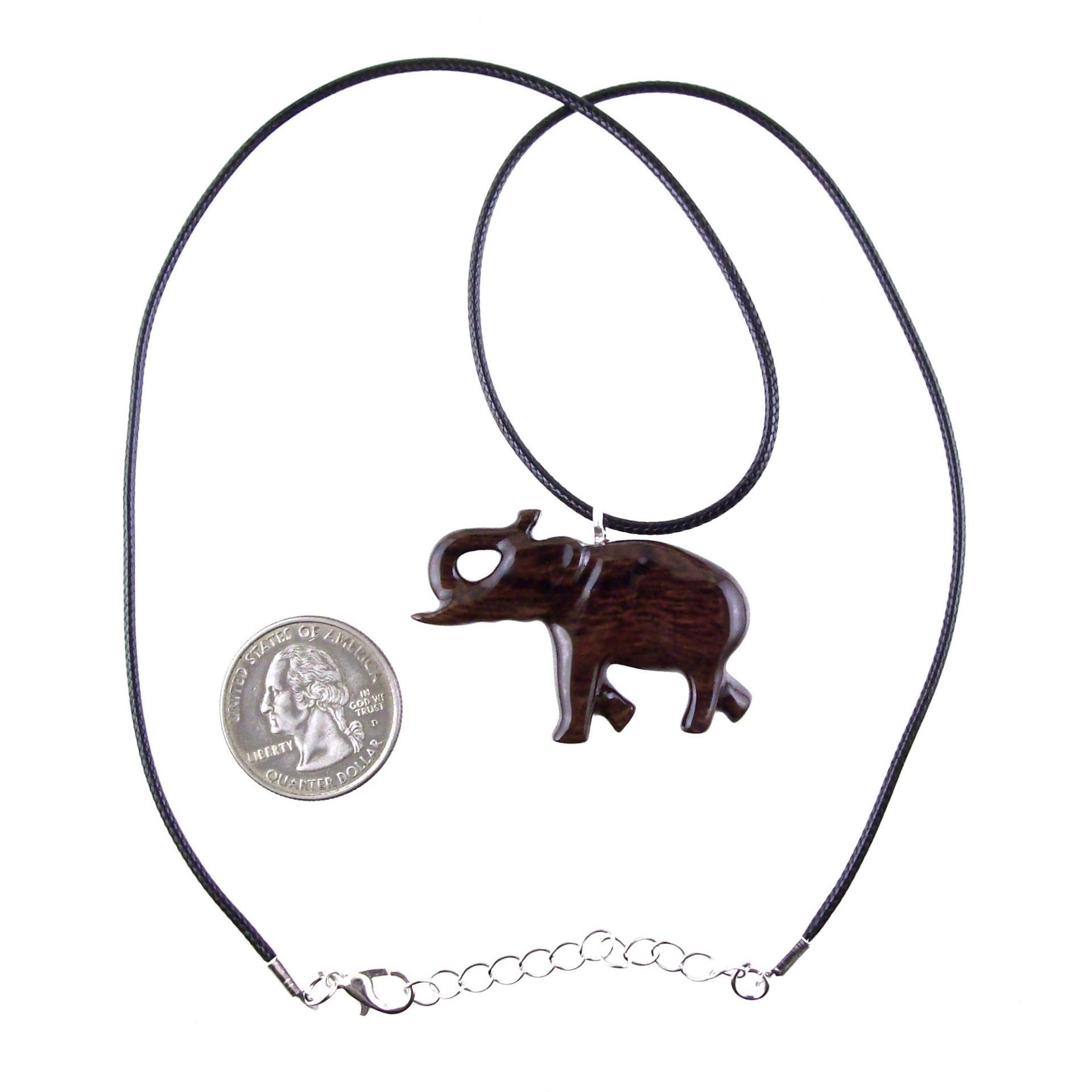 A dark brown wooden elephant pendant necklace with a black cord with silver lobster clasp next to a US quarter for scale.