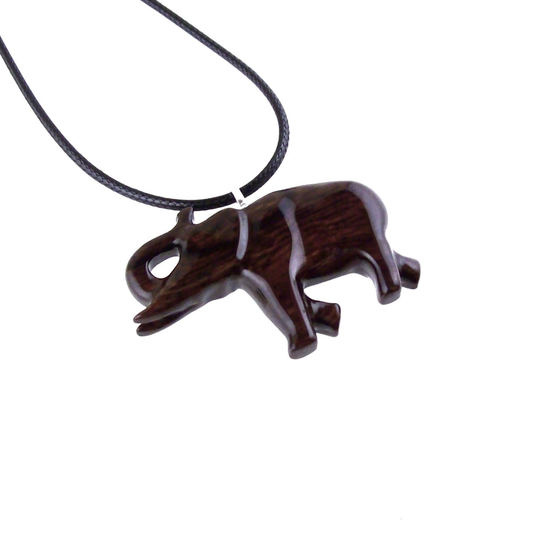 A dark brown wooden elephant pendant on a black cord necklace. The elephant is carved in a detailed, realistic style with a raised trunk and visible texture.