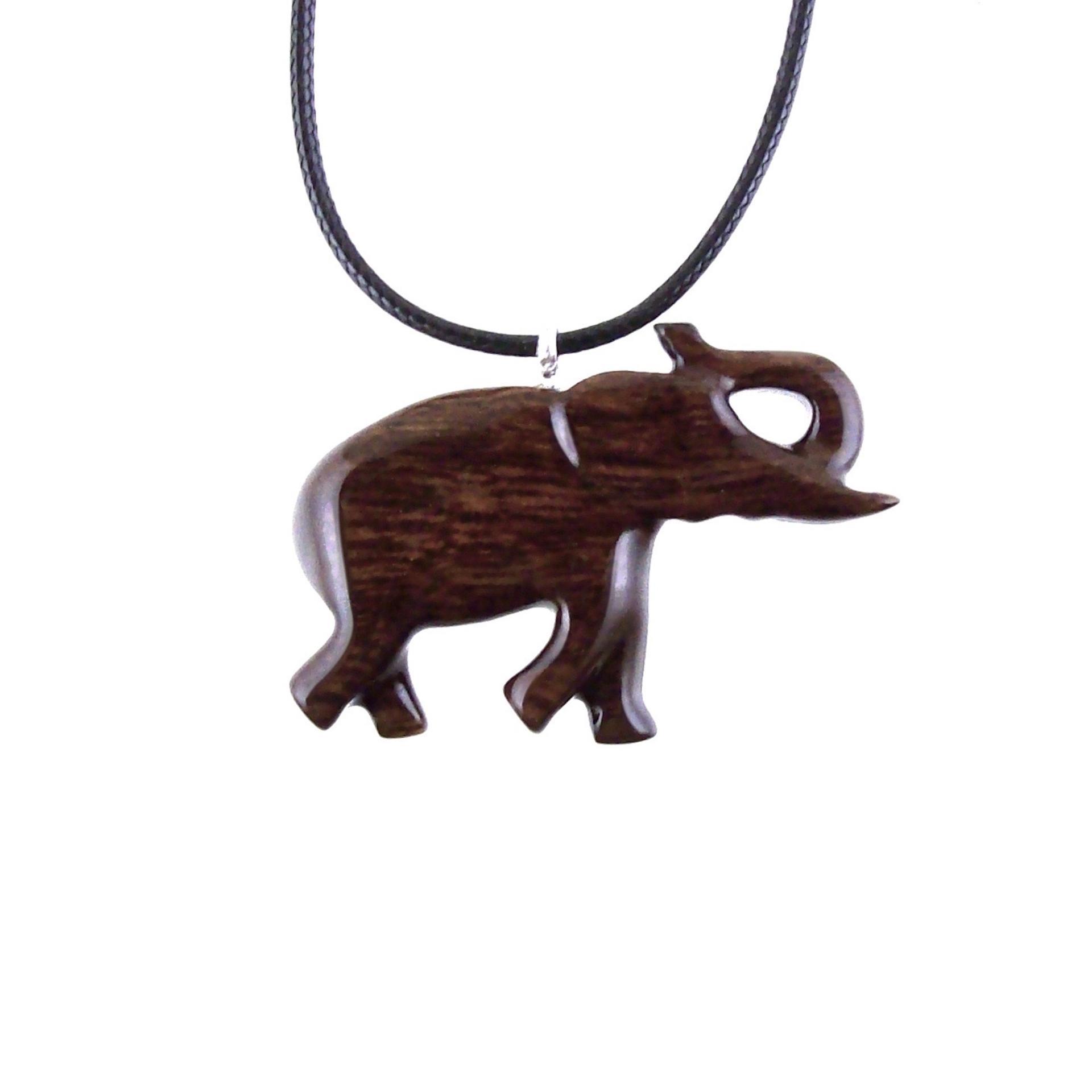 A dark brown wooden elephant pendant necklace with a black cord. The elephant is carved in a walking pose with its trunk raised.
