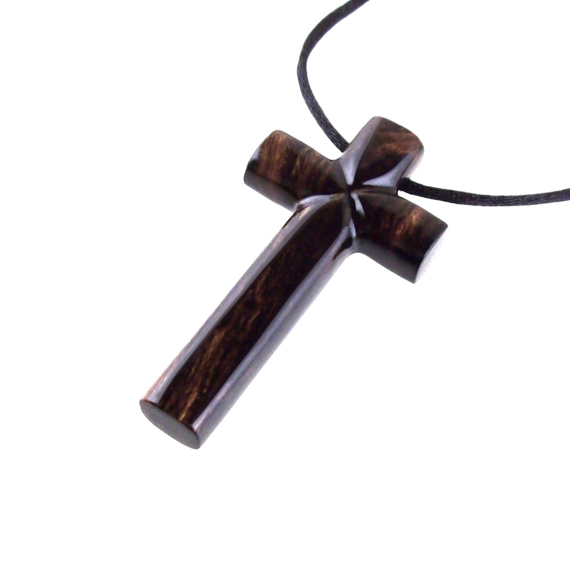 A dark brown wooden cross pendant on a black cord with a glossy smooth finish showing the wood grain.