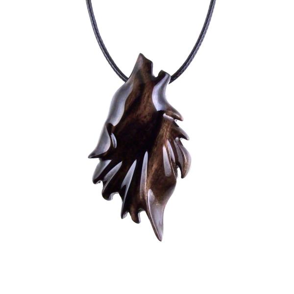 Black with brown streaks wooden howling wolf head pendant with 18 inches black cord necklace with lobster clasp.