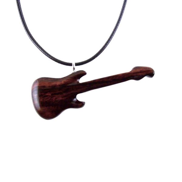 A wooden guitar pendant necklace with a black cord. The guitar is dark reddish- brown with a wood grain pattern.