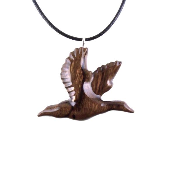 A dark brown wooden duck pendant on a black cord necklace. The bird is carved in flight with its wings spread out.